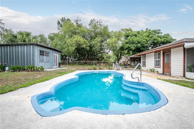 800 Jefferis Ct, Eustis, FL 32726 - view of swimming pool with fence, a patio area, an outbuilding, and view of wooded area