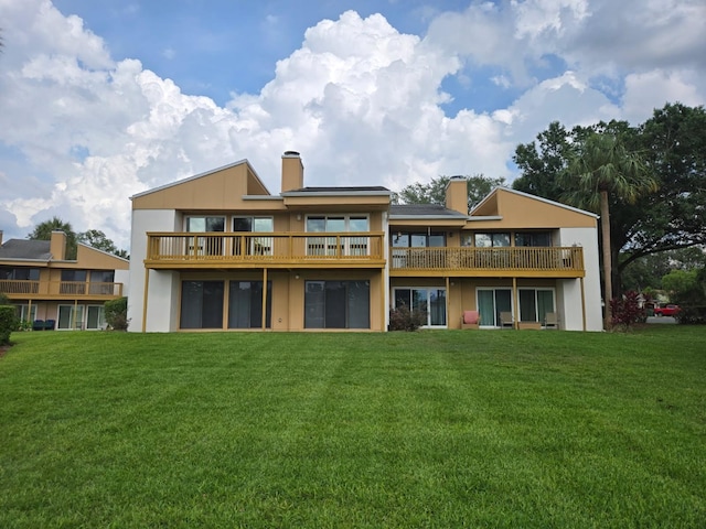1051 S Highland St Unit 4-E, Mount Dora, FL 32757 - rear view of property with a lawn, a chimney, and stucco siding