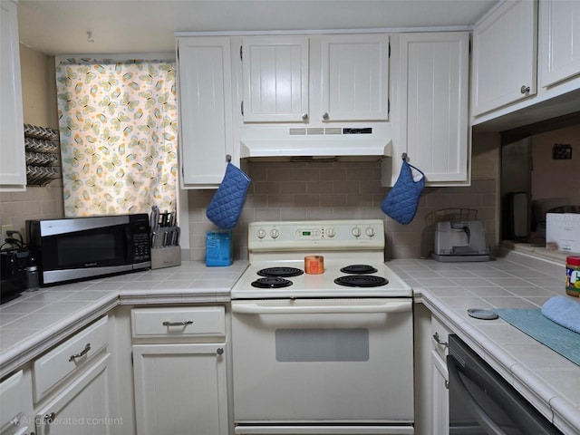 1051 S Highland St Unit 4-E, Mount Dora, FL 32757 - kitchen featuring white electric range oven, under cabinet range hood, stainless steel microwave, dishwasher, and tile counters