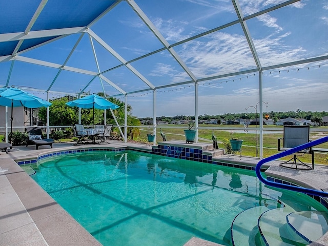 outdoor pool with a patio area and glass enclosure