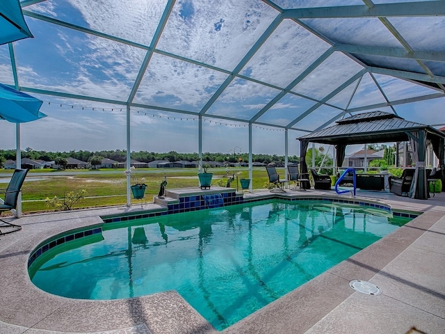 outdoor pool with a patio, a lawn, a gazebo, and glass enclosure