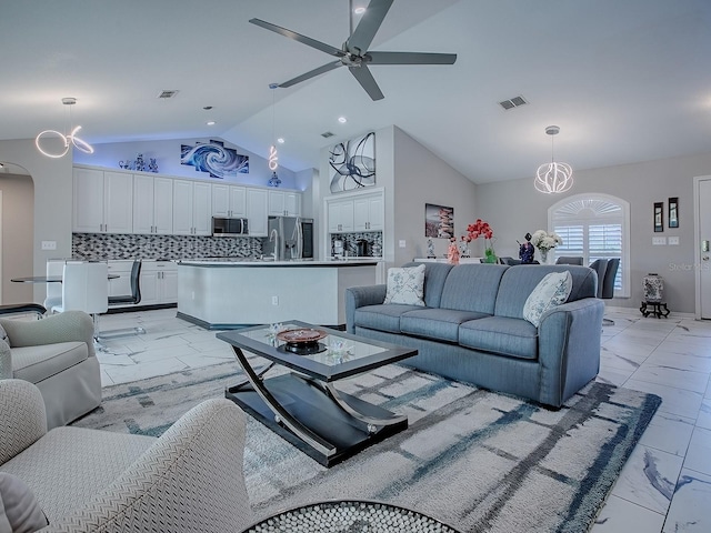 living room with ceiling fan, a chandelier, light marble finish flooring, arched walkways, and recessed lighting