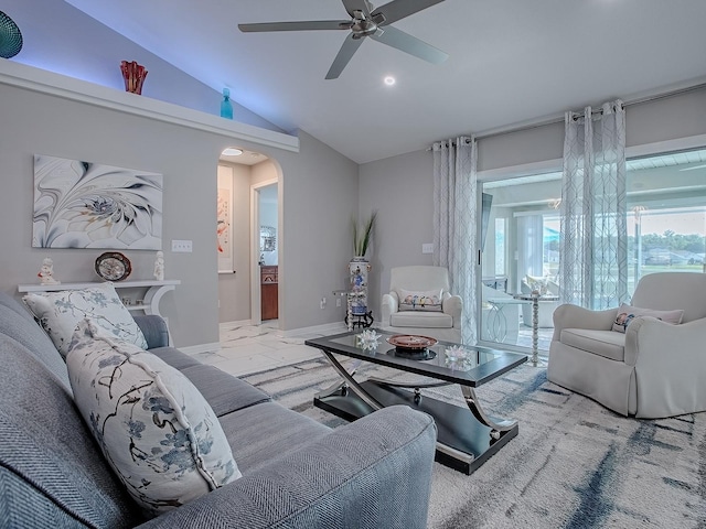 living area with arched walkways, vaulted ceiling, ceiling fan, baseboards, and marble look tile flooring