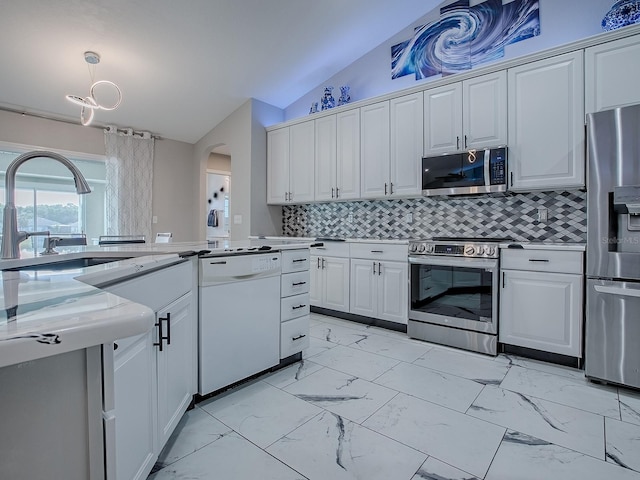 kitchen featuring stainless steel appliances, light marble finish floors, arched walkways, vaulted ceiling, and a sink