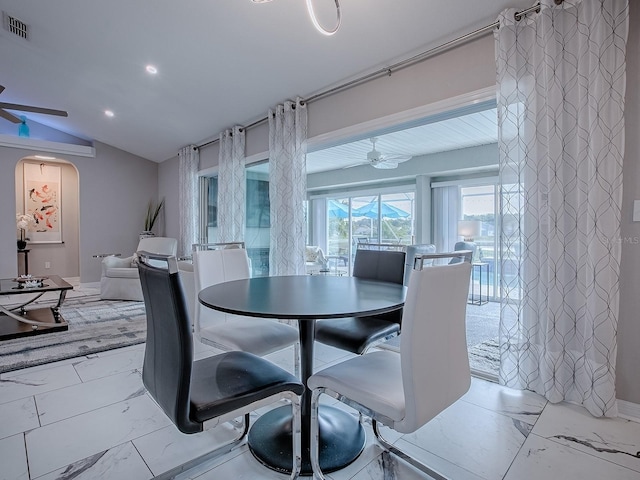 dining space with marble finish floors, vaulted ceiling, arched walkways, recessed lighting, and a ceiling fan