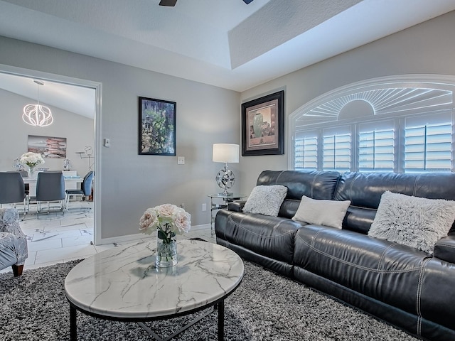 living room featuring light marble finish flooring and baseboards