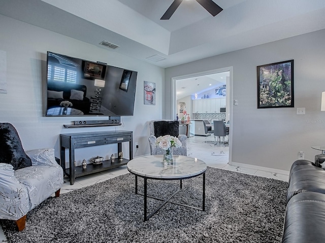 tiled living area with a ceiling fan
