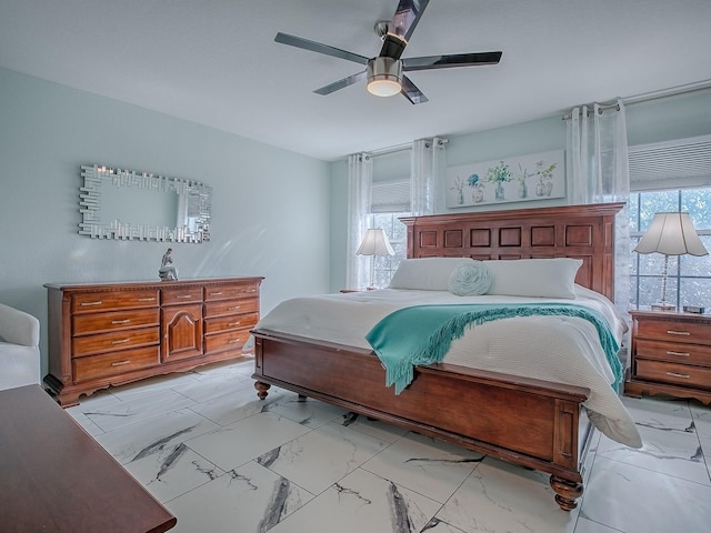 bedroom featuring light marble finish flooring and a ceiling fan