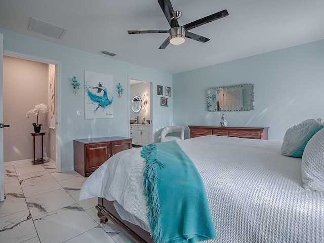 bedroom with light marble finish flooring, ceiling fan, ensuite bathroom, and baseboards