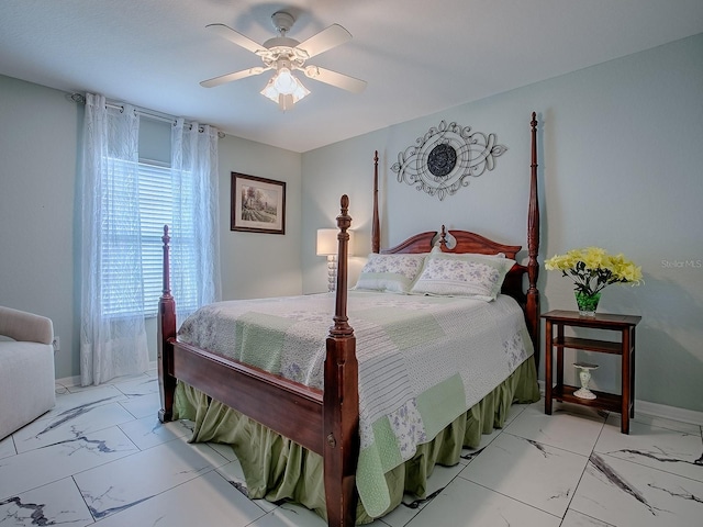 bedroom with light marble finish flooring, ceiling fan, and baseboards
