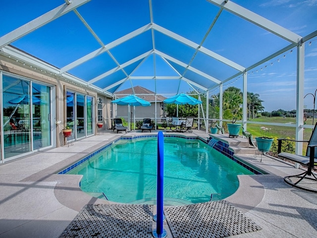 swimming pool with a patio and glass enclosure