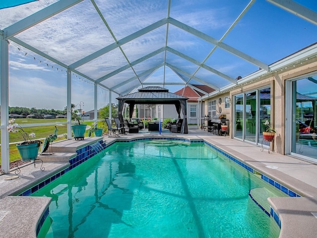 outdoor pool featuring a patio, glass enclosure, and a gazebo