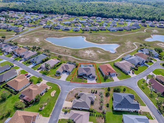 aerial view of residential area featuring a nearby body of water