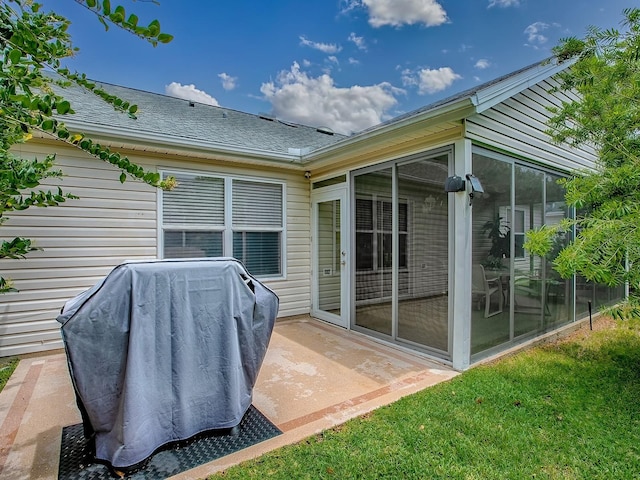 back of property featuring a sunroom and roof with shingles