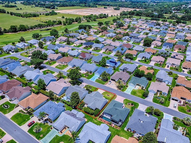 aerial overview of property's location with property parcel outlined, a golf course, and nearby suburban area