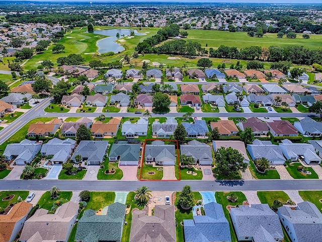 aerial perspective of suburban area featuring a large body of water and a golf club