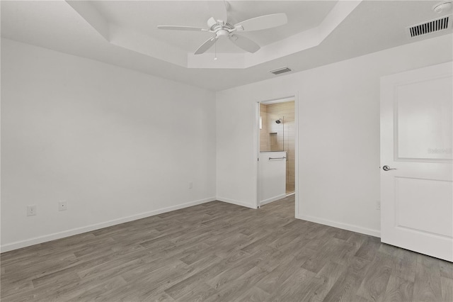 3745 Causey Ct, The Villages, FL 32163 - unfurnished room featuring a tray ceiling, a ceiling fan, wood finished floors, and baseboards