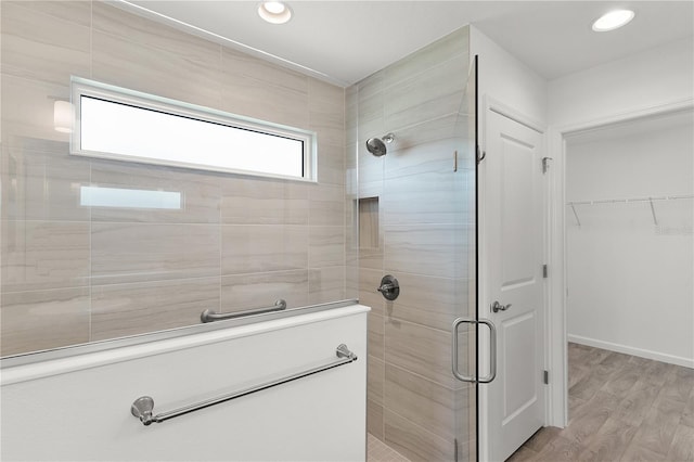 3745 Causey Ct, The Villages, FL 32163 - full bathroom featuring a stall shower, wood finished floors, recessed lighting, and a walk in closet