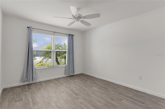 3745 Causey Ct, The Villages, FL 32163 - unfurnished room with wood finished floors, a ceiling fan, and baseboards