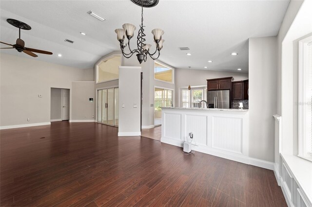 6259 SE 120th Pl, Belleview, FL 34420 - unfurnished living room with a ceiling fan, a chandelier, high vaulted ceiling, dark wood-style flooring, and recessed lighting