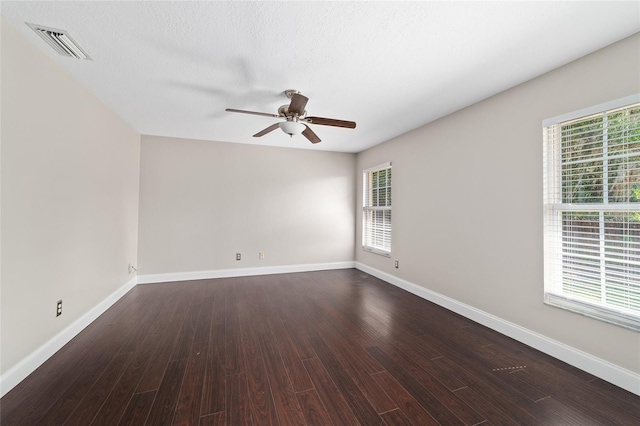 6259 SE 120th Pl, Belleview, FL 34420 - spare room with a ceiling fan, healthy amount of natural light, dark wood-type flooring, and baseboards