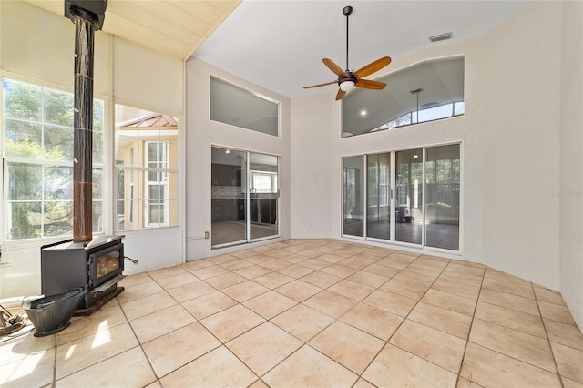 6259 SE 120th Pl, Belleview, FL 34420 - unfurnished sunroom featuring a wood stove, plenty of natural light, and lofted ceiling