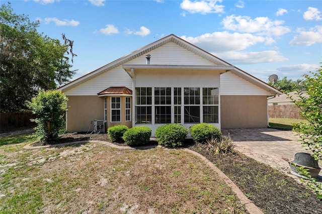 6259 SE 120th Pl, Belleview, FL 34420 - back of house featuring stucco siding and a patio