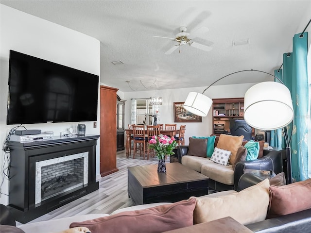 1202 Del Toro Dr, Lady Lake, FL 32159 - living area featuring a ceiling fan, a textured ceiling, and light wood-style floors