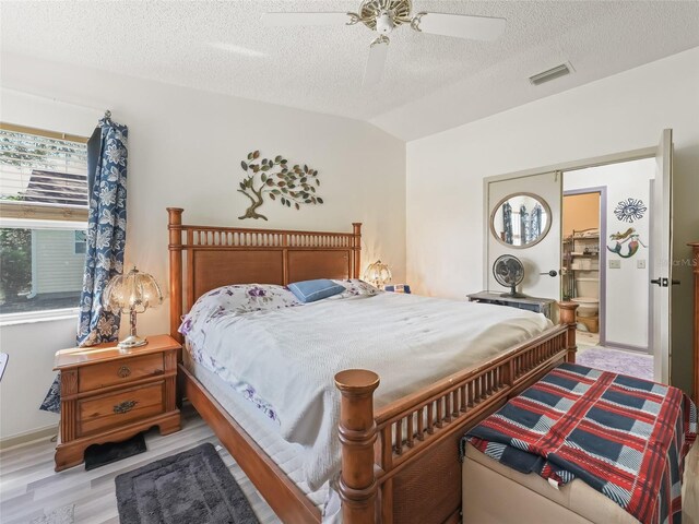 1202 Del Toro Dr, Lady Lake, FL 32159 - bedroom with a textured ceiling, lofted ceiling, light wood-style flooring, ceiling fan, and baseboards