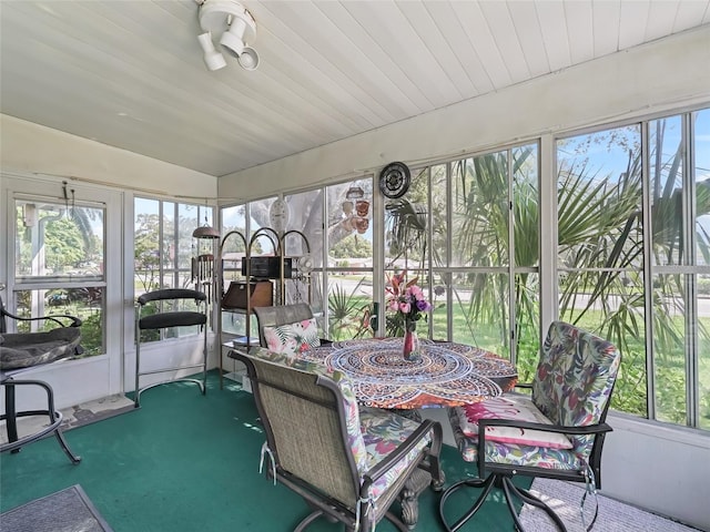 1202 Del Toro Dr, Lady Lake, FL 32159 - sunroom with carpet, lofted ceiling, and outdoor dining area