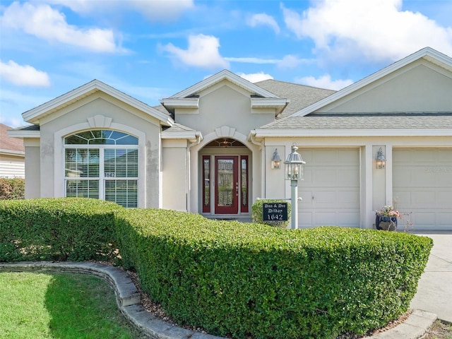 1642 Pennecamp Dr, The Villages, FL 32162 - view of front of home featuring stucco siding, a garage, roof with shingles, and concrete driveway