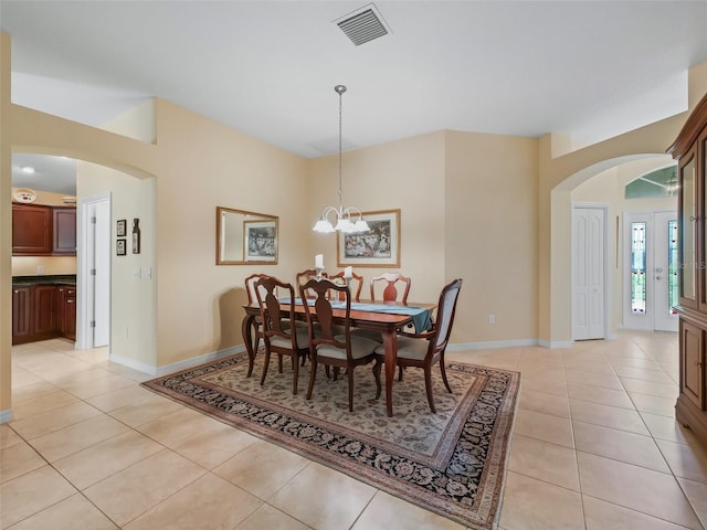 1642 Pennecamp Dr, The Villages, FL 32162 - dining room featuring arched walkways, light tile patterned floors, baseboards, and a chandelier