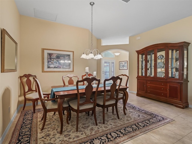 1642 Pennecamp Dr, The Villages, FL 32162 - dining area with arched walkways, baseboards, light tile patterned flooring, and a chandelier