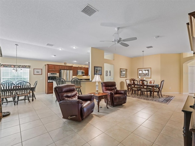 1642 Pennecamp Dr, The Villages, FL 32162 - living room featuring arched walkways, a chandelier, light tile patterned floors, ceiling fan, and a textured ceiling