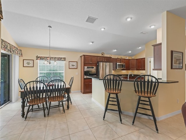 1642 Pennecamp Dr, The Villages, FL 32162 - dining area with a chandelier, light tile patterned floors, and lofted ceiling