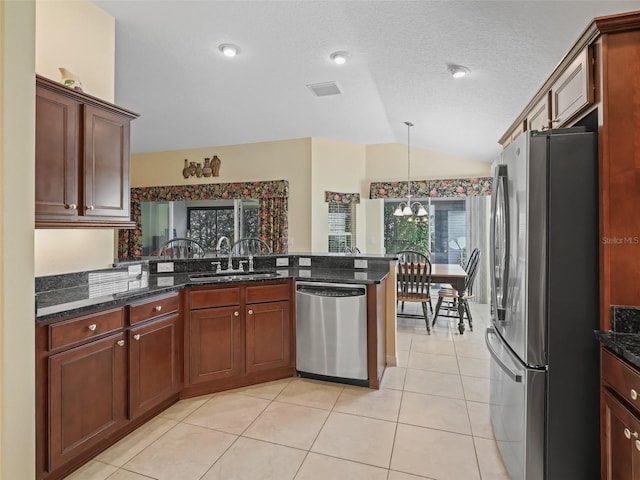 1642 Pennecamp Dr, The Villages, FL 32162 - kitchen featuring appliances with stainless steel finishes, vaulted ceiling, a sink, a peninsula, and hanging light fixtures