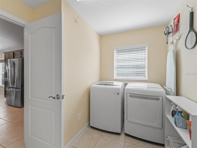 1642 Pennecamp Dr, The Villages, FL 32162 - laundry area with washer and dryer, light tile patterned floors, and baseboards