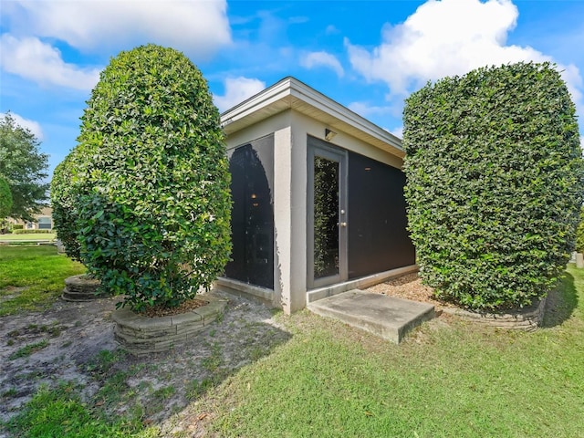1642 Pennecamp Dr, The Villages, FL 32162 - view of side of property with stucco siding and a lawn