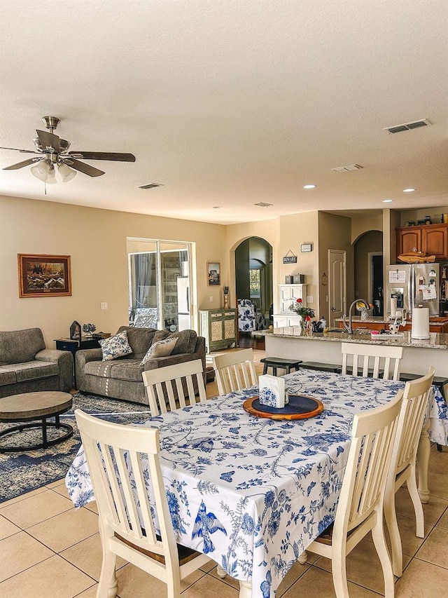 33818 Venice Ln, Sorrento, FL 32776 - dining area featuring arched walkways, light tile patterned flooring, a ceiling fan, and recessed lighting