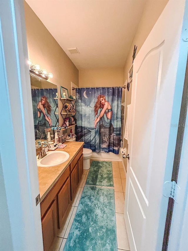 33818 Venice Ln, Sorrento, FL 32776 - bathroom with tile patterned flooring, toilet, vanity, and shower / tub combo