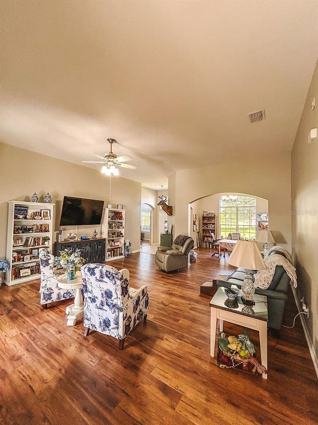 33818 Venice Ln, Sorrento, FL 32776 - living room with healthy amount of natural light, wood finished floors, arched walkways, and a ceiling fan