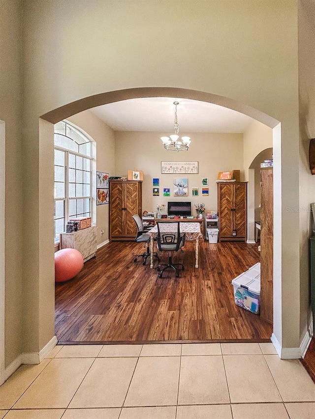 33818 Venice Ln, Sorrento, FL 32776 - dining room with arched walkways, tile patterned floors, baseboards, and a chandelier