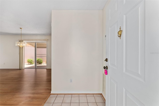 403 Duarte Ln, The Villages, FL 32159 - empty room with a chandelier, baseboards, and light wood finished floors