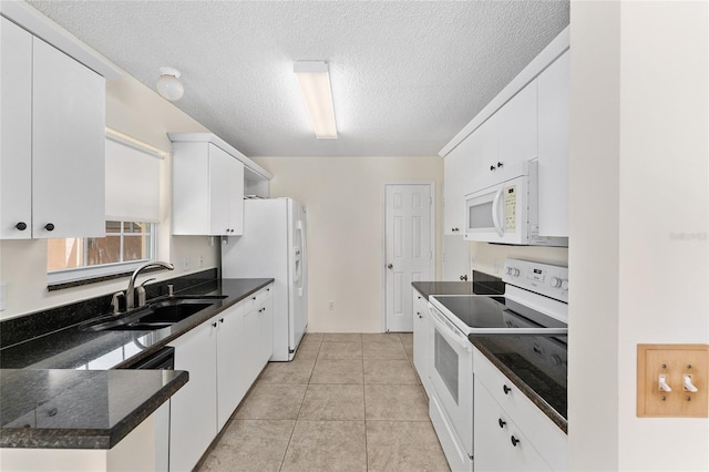 403 Duarte Ln, The Villages, FL 32159 - kitchen featuring white appliances, a sink, white cabinets, a textured ceiling, and light tile patterned flooring