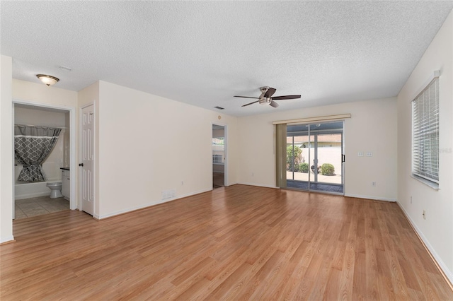403 Duarte Ln, The Villages, FL 32159 - empty room with a textured ceiling, light wood-type flooring, ceiling fan, and baseboards