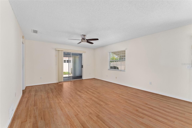 403 Duarte Ln, The Villages, FL 32159 - unfurnished room featuring light wood-style flooring, ceiling fan, a textured ceiling, and baseboards