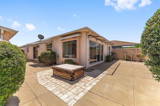 403 Duarte Ln, The Villages, FL 32159 - back of house featuring a patio, stucco siding, and fence