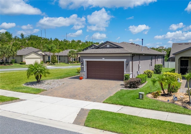 503 Vigo St, Davenport, FL 33837 - ranch-style home with stucco siding, a front lawn, decorative driveway, a garage, and a residential view