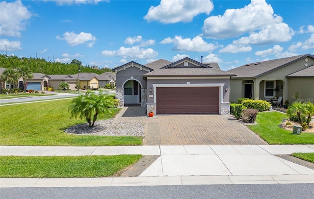 503 Vigo St, Davenport, FL 33837 - ranch-style home with stucco siding, a front yard, stone siding, and a garage