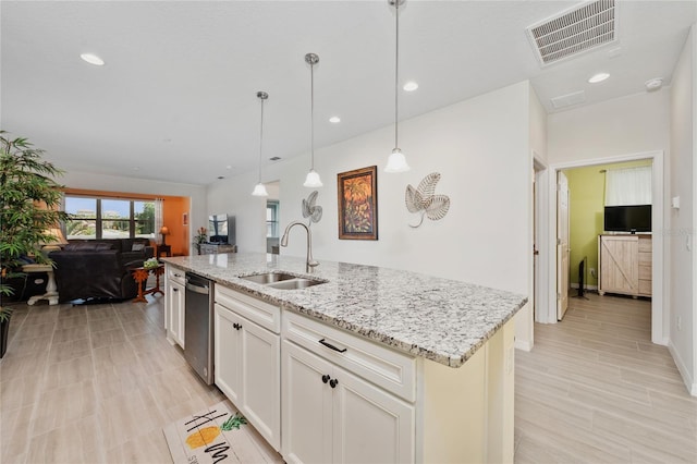 503 Vigo St, Davenport, FL 33837 - kitchen featuring a sink, dishwasher, open floor plan, light stone countertops, and recessed lighting